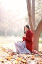 Reading in nature is my hobby,Girl with book and tea in the autumn park Royalty Free Stock Photo